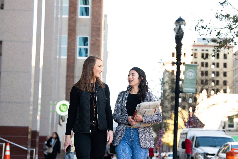 Two Davis College of Business & Technology students walking near the JU downtown campus.