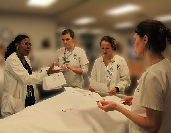 Nursing students being taught by a Baptist Health nursing professional.